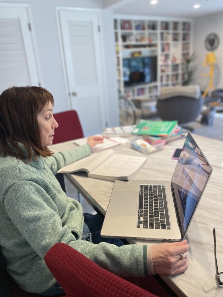 Teacher providing help with Spanish homework